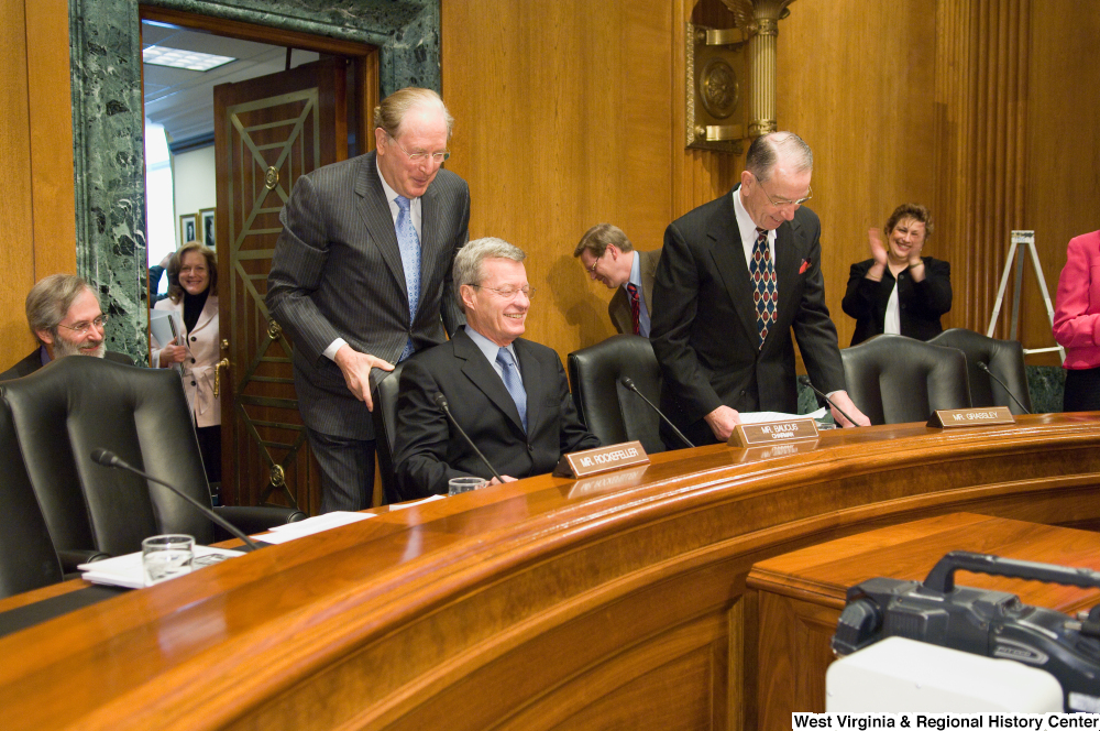 ["Senator John D. (Jay) Rockefeller helps push in Senator Max Baucus."]%