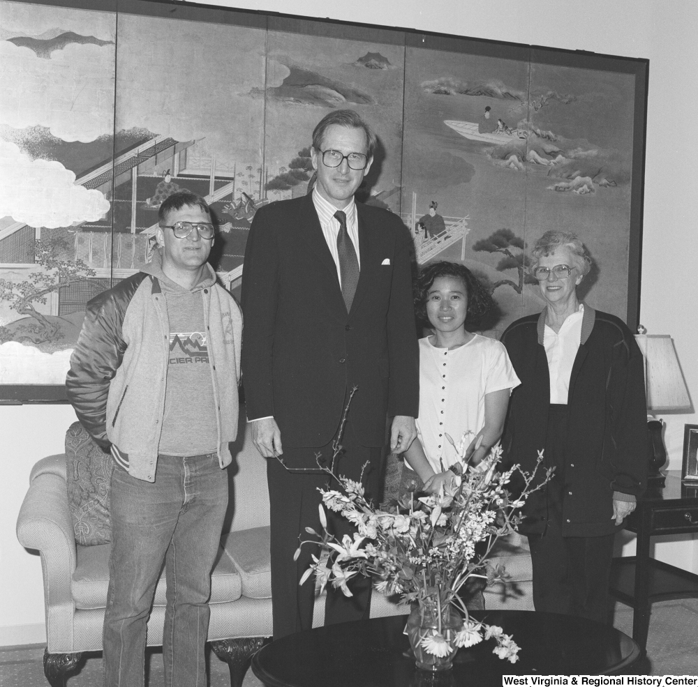 ["Senator John D. (Jay) Rockefeller stands with three individuals in his office."]%