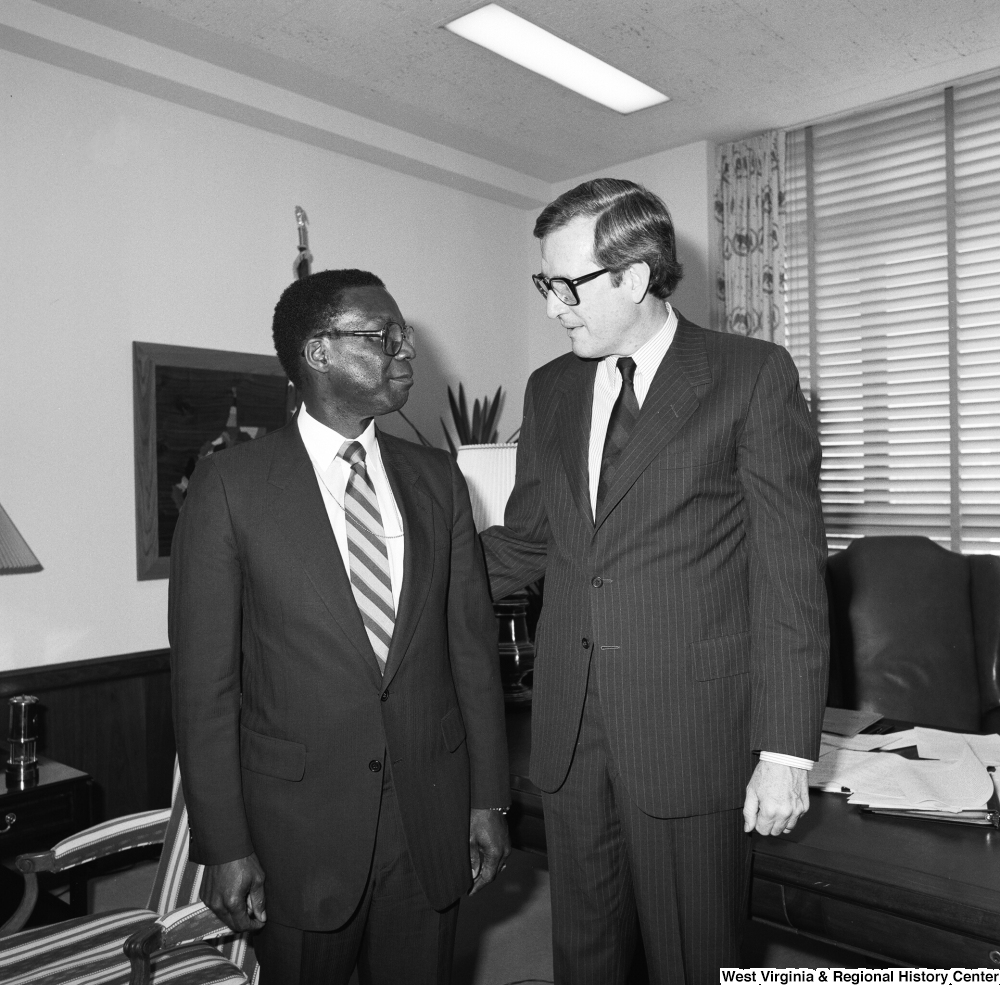 ["Senator John D. (Jay) Rockefeller stands in front of the desk in his office with FEMA Director Julius Beckton."]%