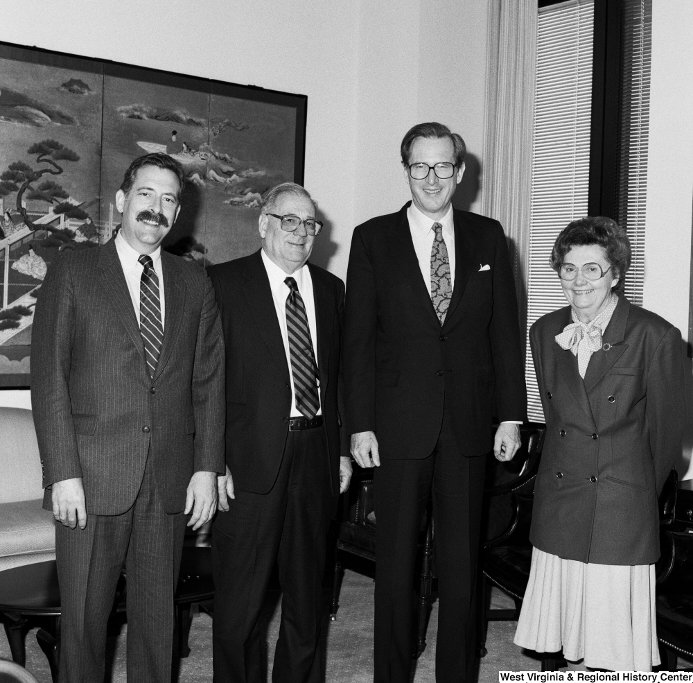 ["Senator John D. (Jay) Rockefeller stands in his office with three unidentified guests."]%