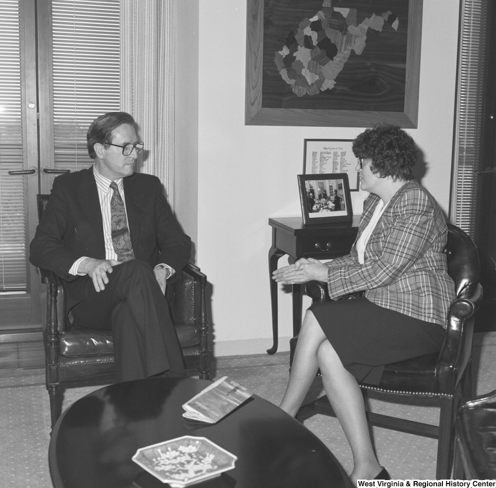 ["Senator John D. (Jay) Rockefeller listens to an unidentified woman in his office."]%