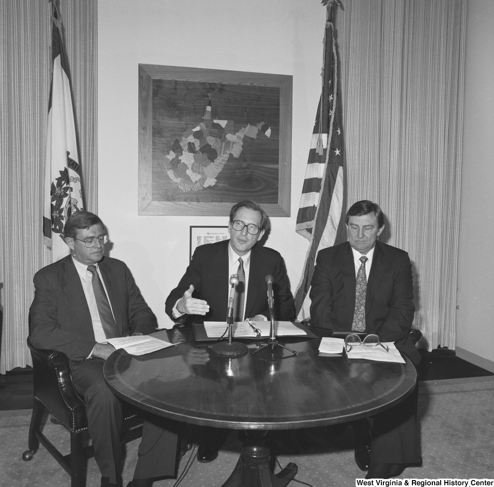 ["Senator John D. (Jay) Rockefeller sits with two representatives from Consumers United for Rail Equity and the National Coal Association during a press event to announce West Virginia coal savings."]%