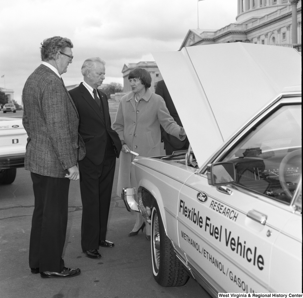 ["Senator Robert C. Byrd looks at the engine of a Ford Flexible Fuel Vehicle."]%