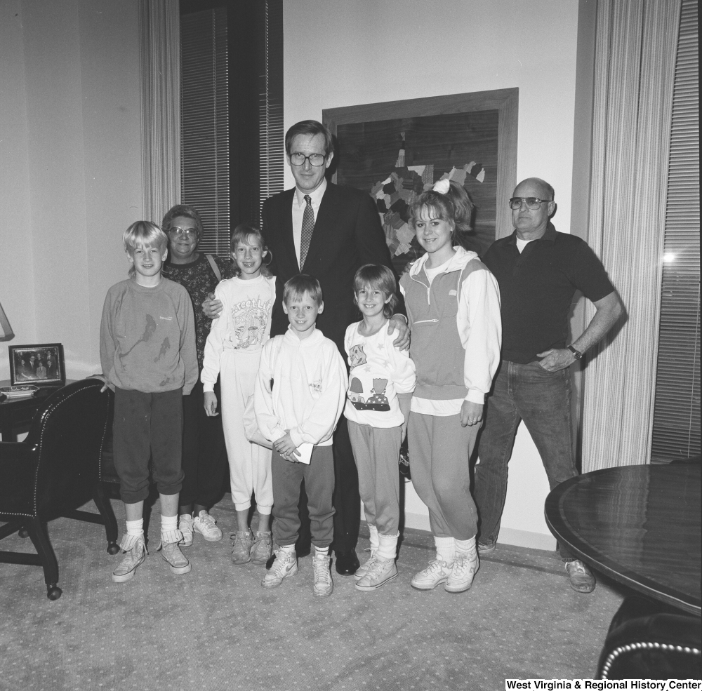["Senator John D. (Jay) Rockefeller stands with a family in his office."]%
