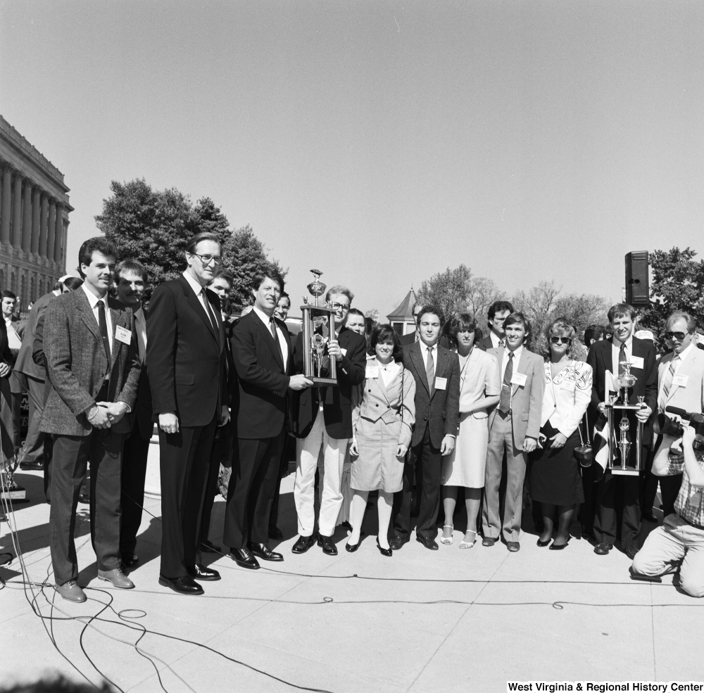 ["Senator John D. (Jay) Rockefeller and Senator Al Gore stand with the winners of a clean vehicle competition outside the Senate."]%