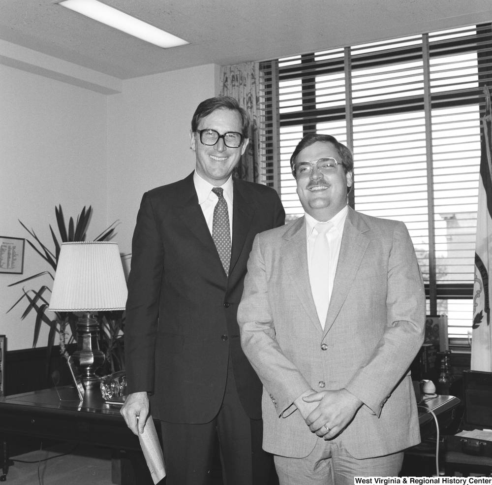 ["Senator John D. (Jay) Rockefeller stands for a photograph with an unidentified man in his office."]%