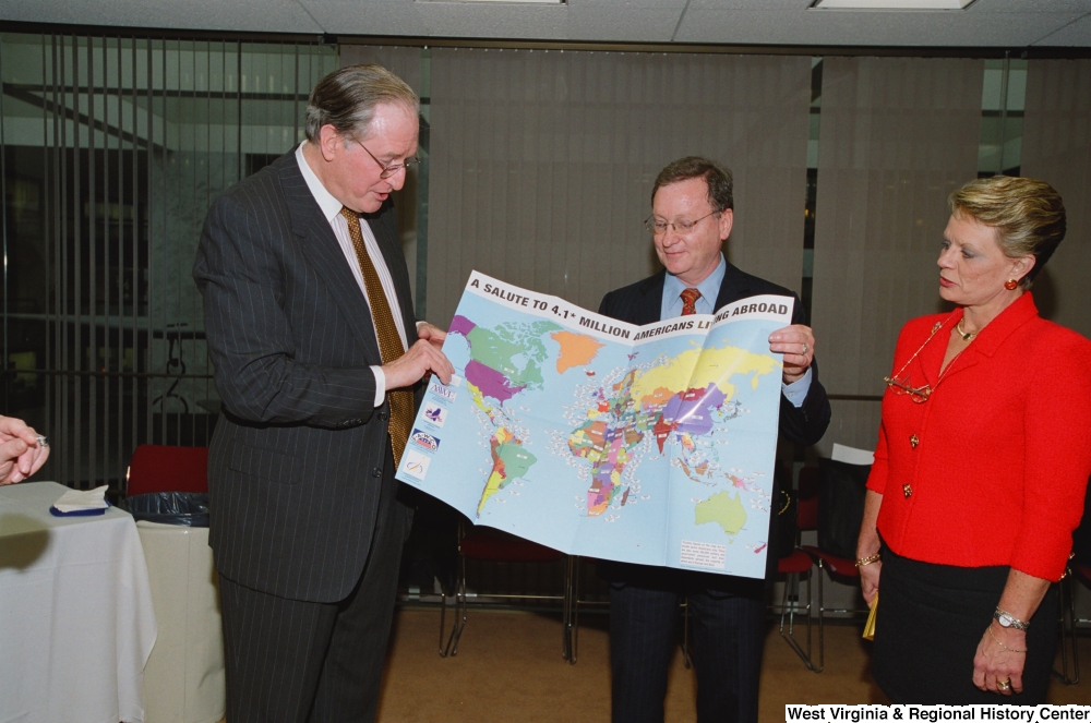 ["Senator John D. (Jay) Rockefeller holds a map titled \"A Salute to 4.1* Million Americans Living Abroad\" as he attends a recognition ceremony hosted by the Federation of American Women's Clubs Overseas."]%