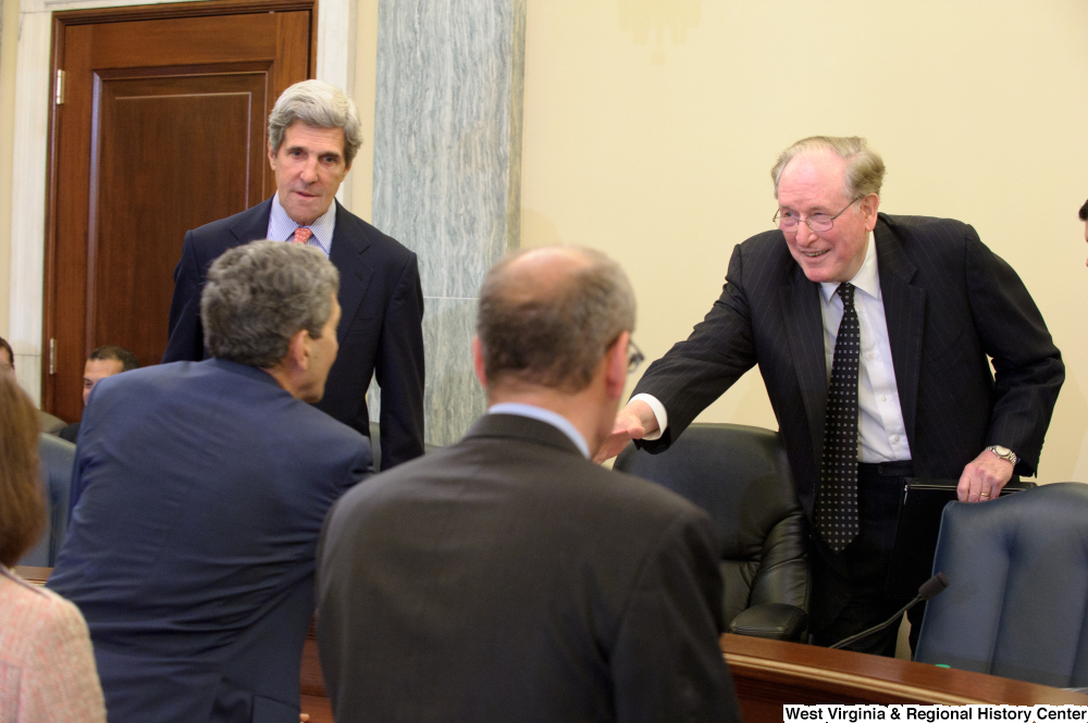 ["Senators John D. (Jay) Rockefeller and John Kerry shaking hands with people after a Commerce Committee hearing."]%