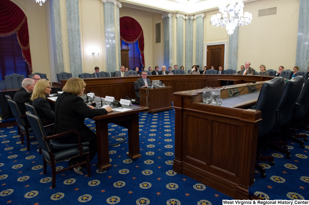 ["This image is of the committee room of a Commerce Committee hearing."]%