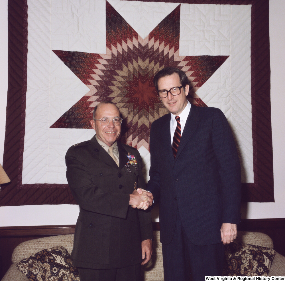 ["Senator John D. (Jay) Rockefeller and retiring Major General Gregory A. Corliss shake hands and pose for a photograph in the Senator's Washington office."]%