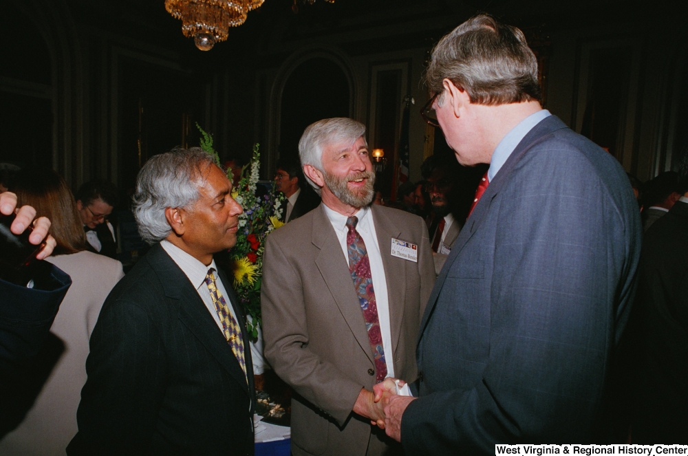 ["Senator John D. (Jay) Rockefeller and a doctor shake hands at a Celebrating Telemedicine conference."]%