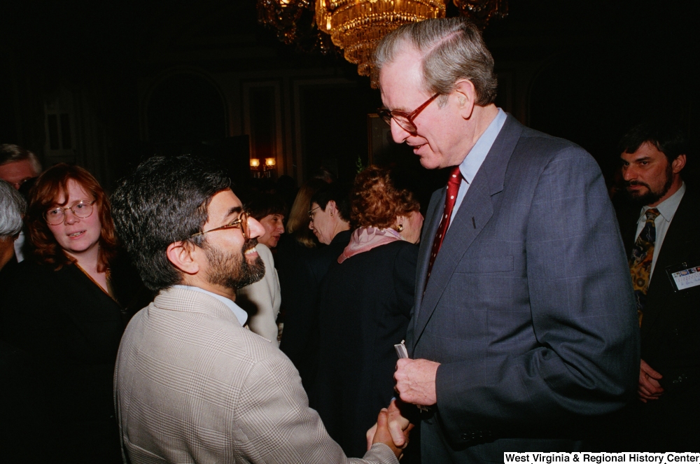 ["Senator John D. (Jay) Rockefeller shakes hands with an unidentified man at the Celebrating Telemedicine conference."]%