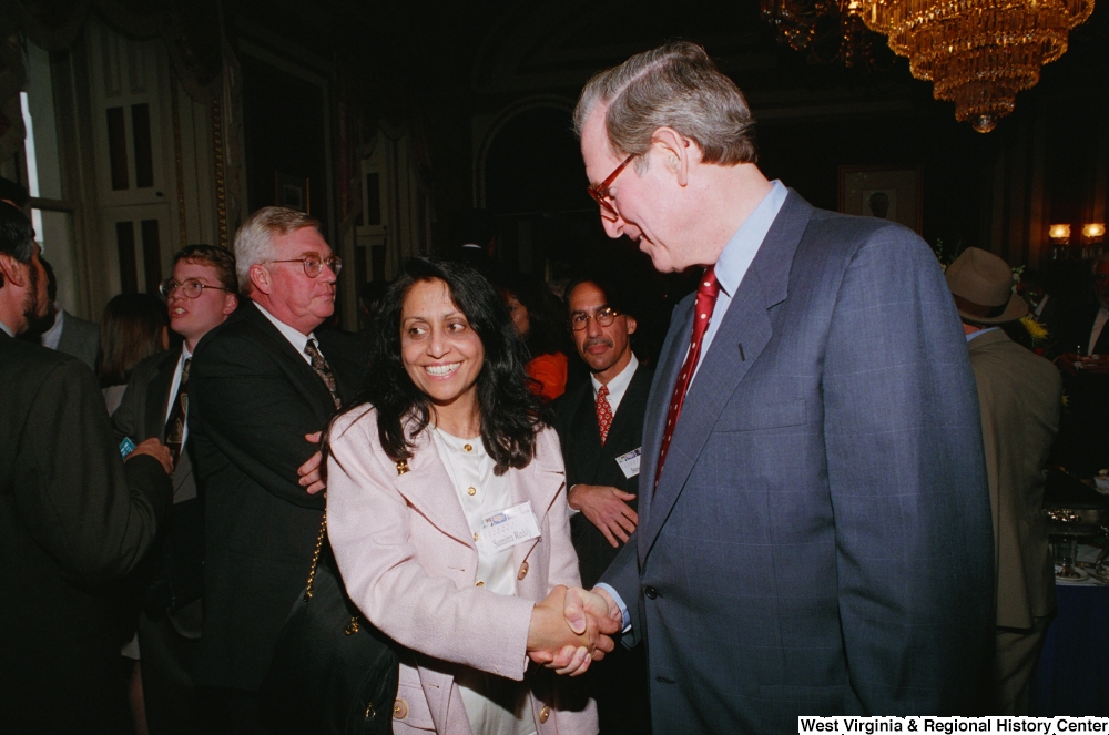 ["Senator John D. (Jay) Rockefeller shakes hands with a woman at the Celebrating Telemedicine conference in Washington."]%