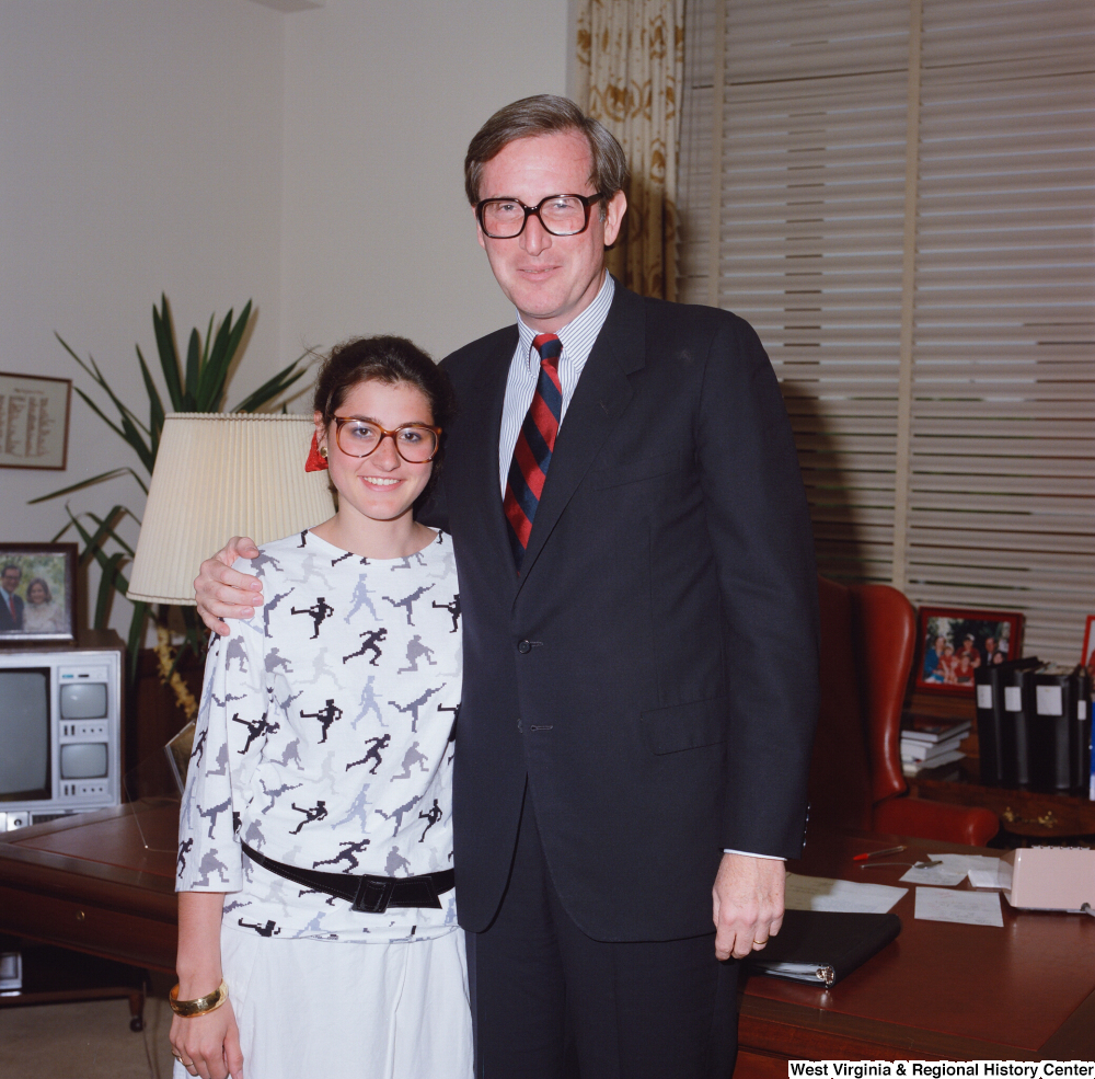 ["This color photograph shows Senator John D. (Jay) Rockefeller embracing an unidentified individual in his office."]%