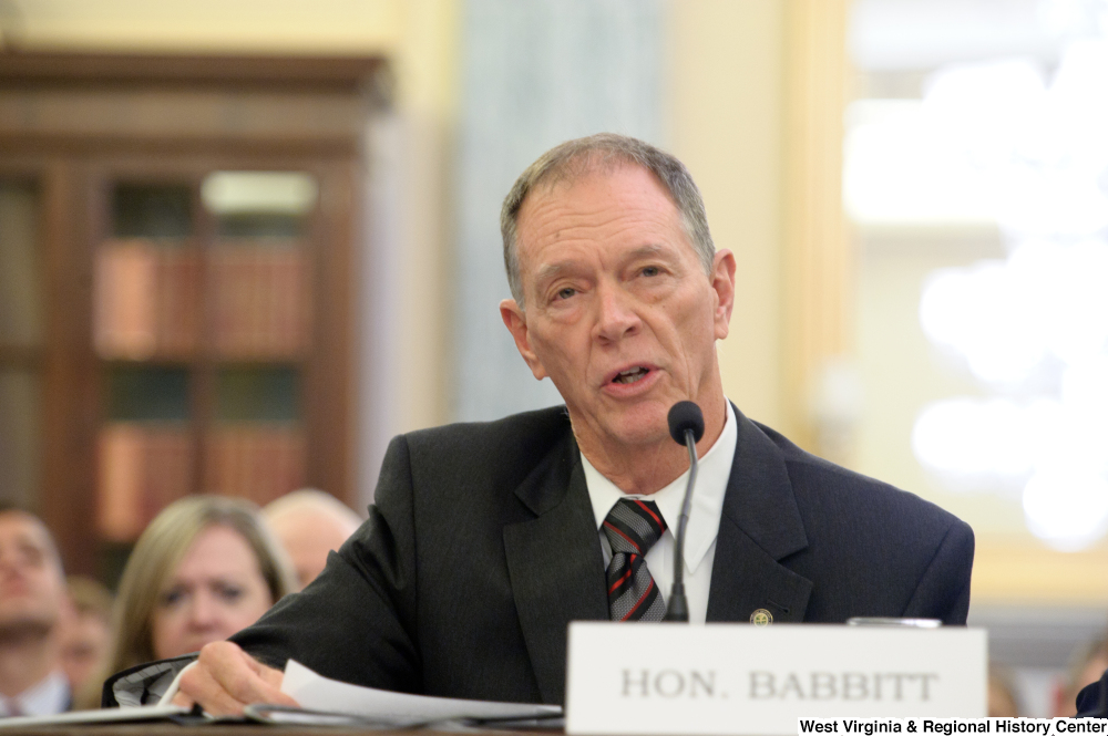 ["A man identified as Honorable Babbitt testifies before a Senate Commerce Committee hearing."]%