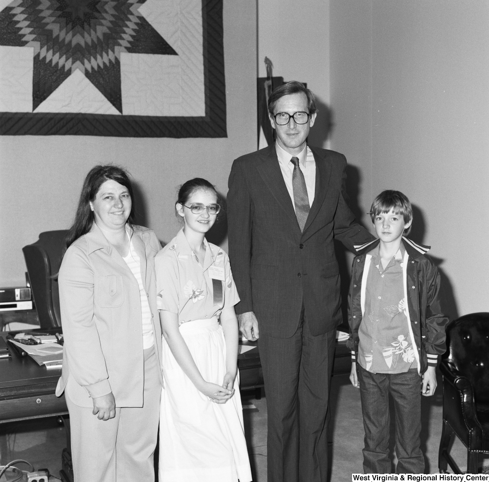 ["Senator John D. (Jay) Rockefeller stands for a photograph with a participant of the Scripps National Spelling Bee and her family."]%