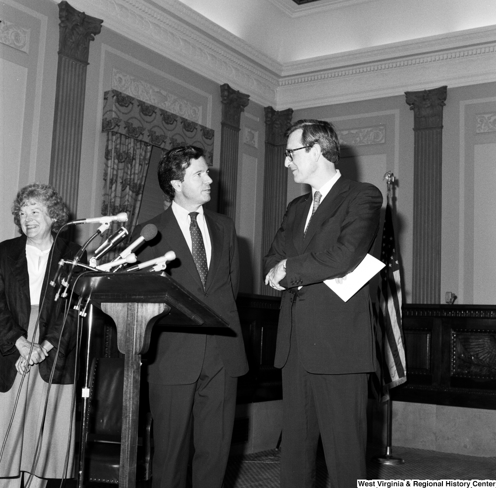 ["Senator John D. (Jay) Rockefeller and Senator John Heinz smile at one another after they have spoken to an audience about the Dislocated Workers Improvement Act of 1987."]%