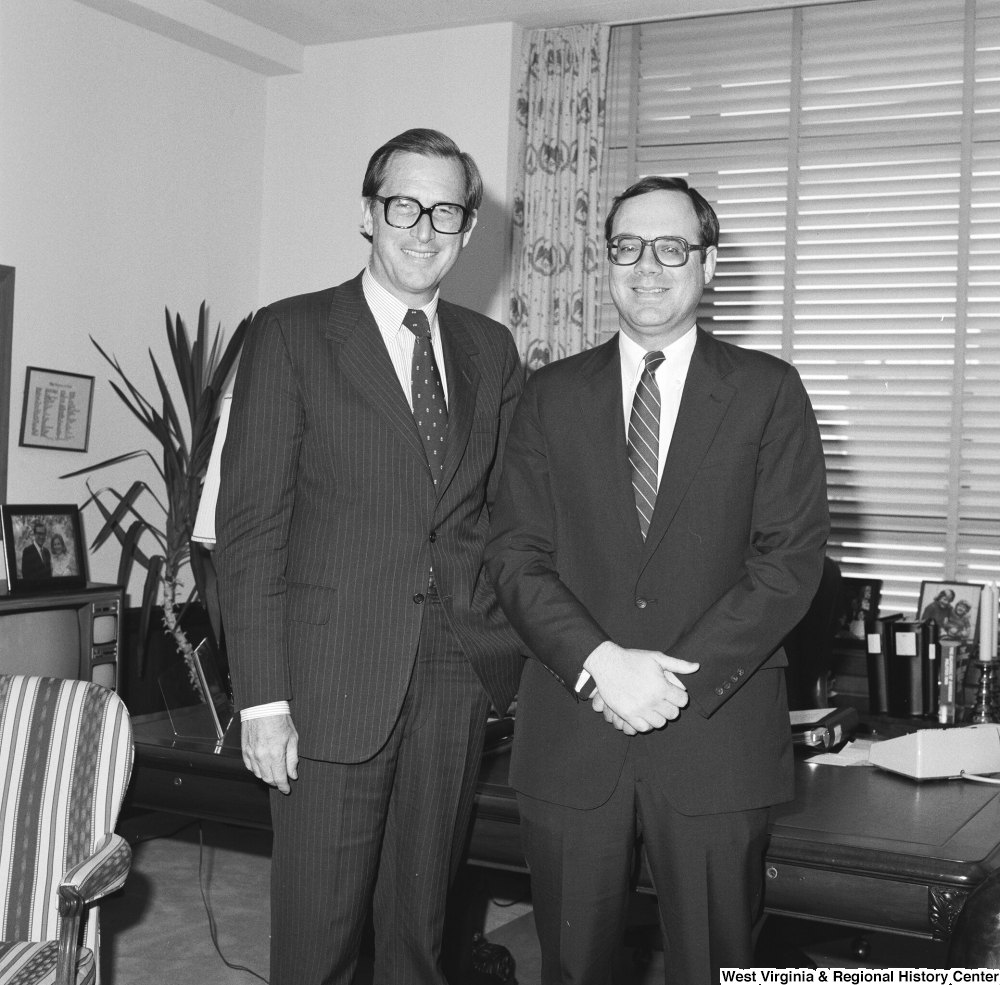 ["Senator John D. (Jay) Rockefeller stands in his office for a photograph with an unidentified man."]%