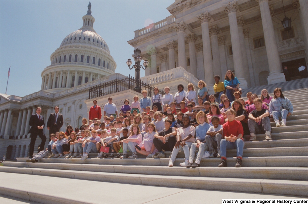 ["Senator John D. (Jay) Rockefeller stands beside a group of West Virginia students on the steps of the Senate."]%
