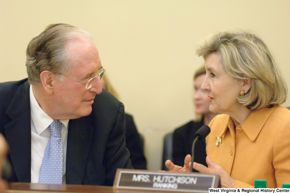 ["Senators John D. (Jay) Rockefeller and Kay Hutchison chat during a Commerce Committee hearing."]%