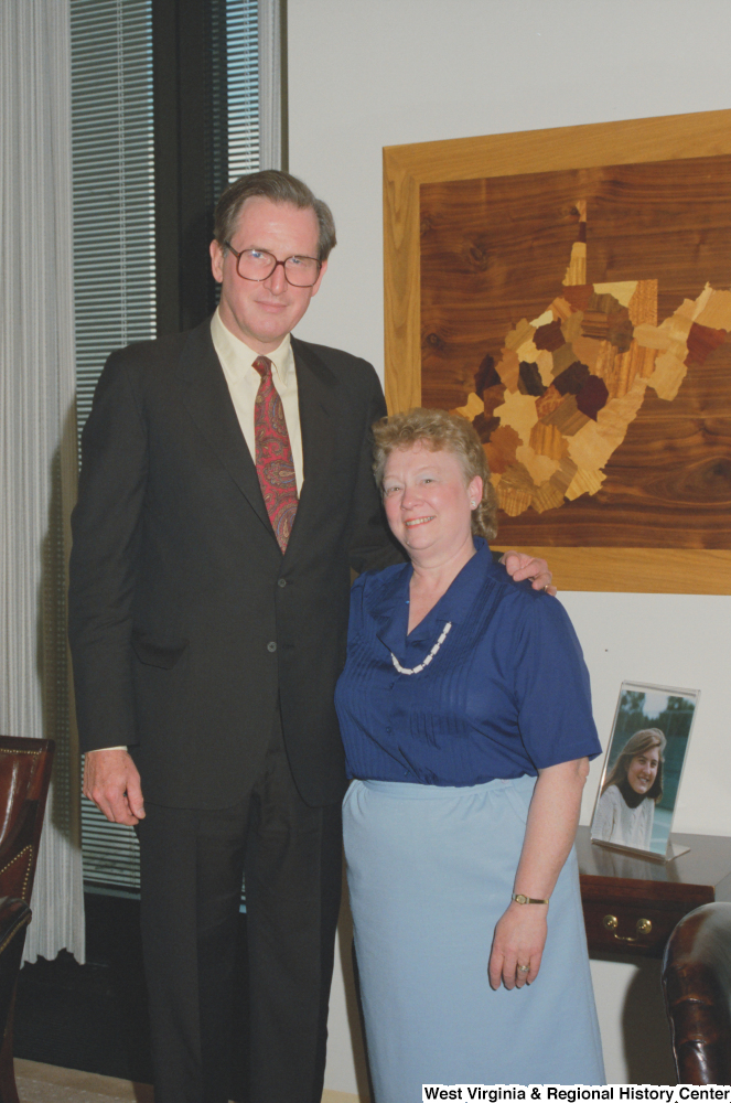 ["Senator John D. (Jay) Rockefeller stands next to an unidentified woman in his office."]%