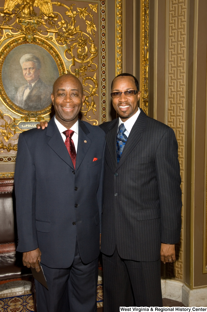 ["Two unidentified men stand next to one another in the Senate."]%