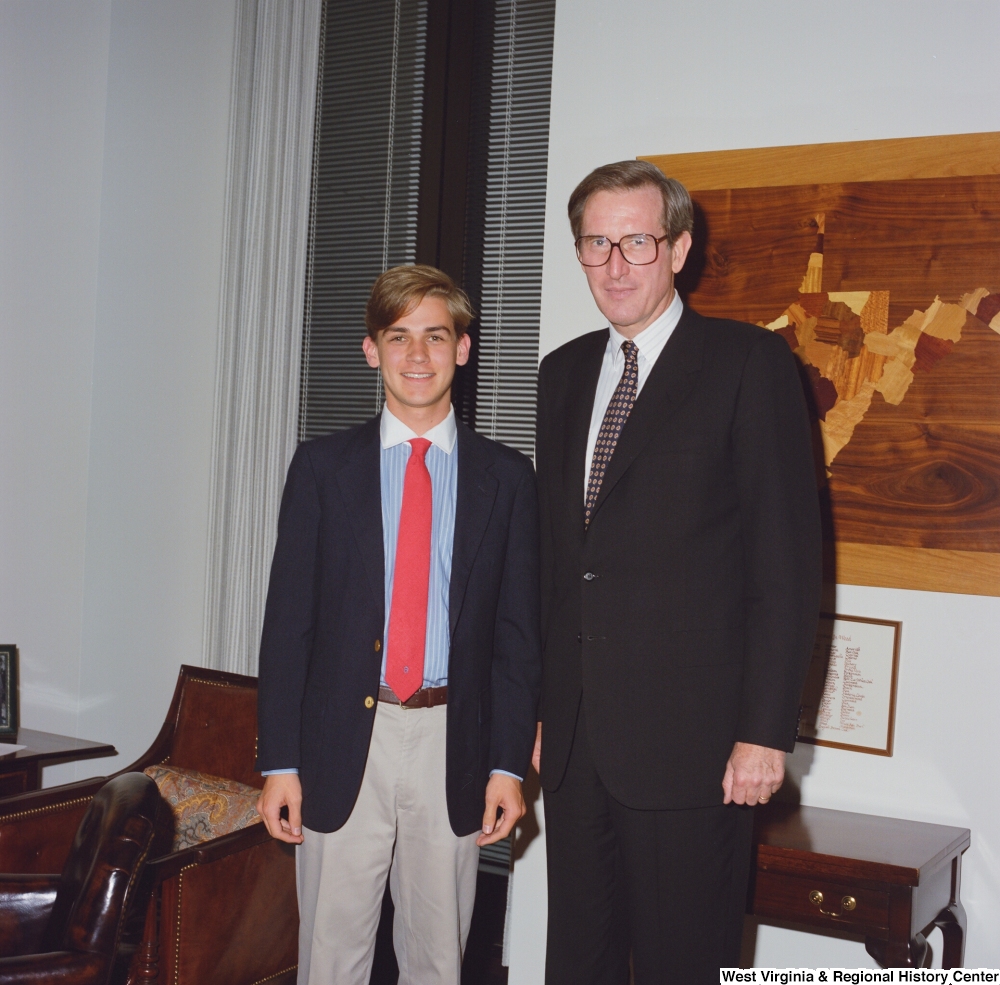 ["Senator John D. (Jay) Rockefeller stands next to an unidentified young man."]%