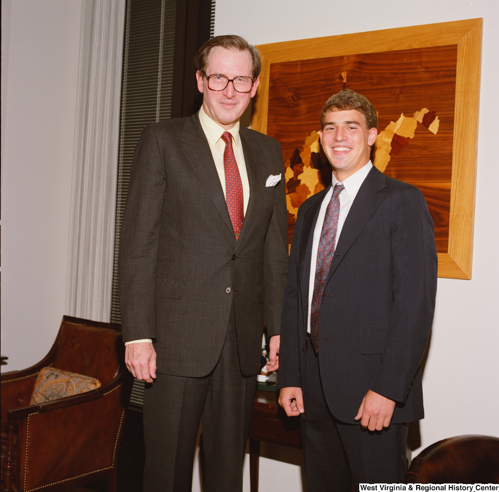["An intern stands next to Senator John D. (Jay) Rockefeller in his office."]%