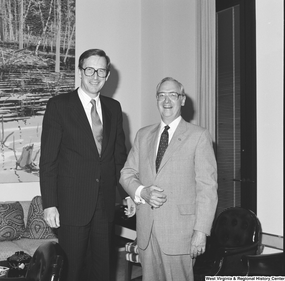 ["Senator John D. (Jay) Rockefeller stands in his office next to the president of West Virginia Research."]%