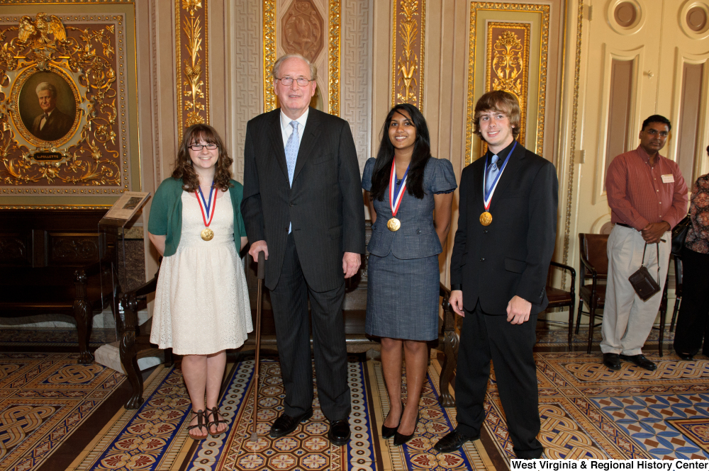 ["Senator John D. (Jay) Rockefeller stands with three West Virginia high school graduates who won the Presidential Scholars award."]%