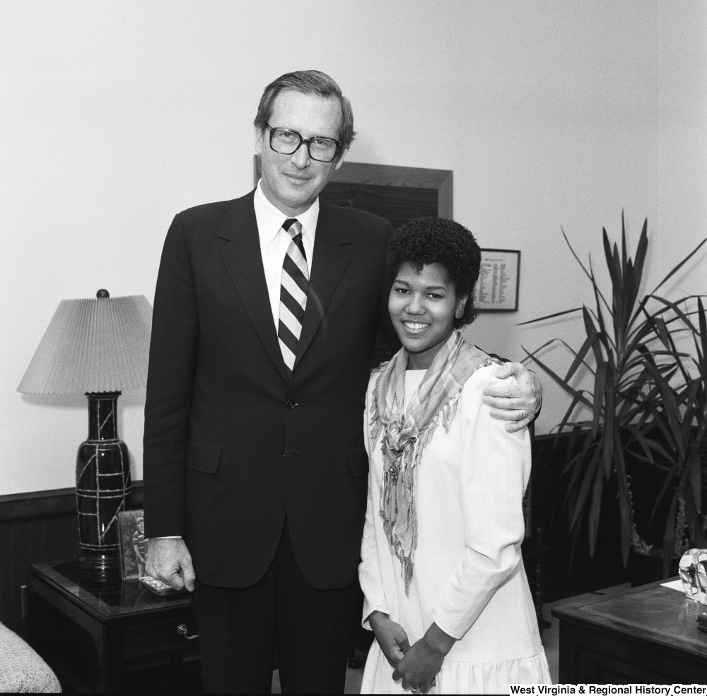 ["An unknown individual stands for a photograph with Senator John D. (Jay) Rockefeller in his Washington office."]%