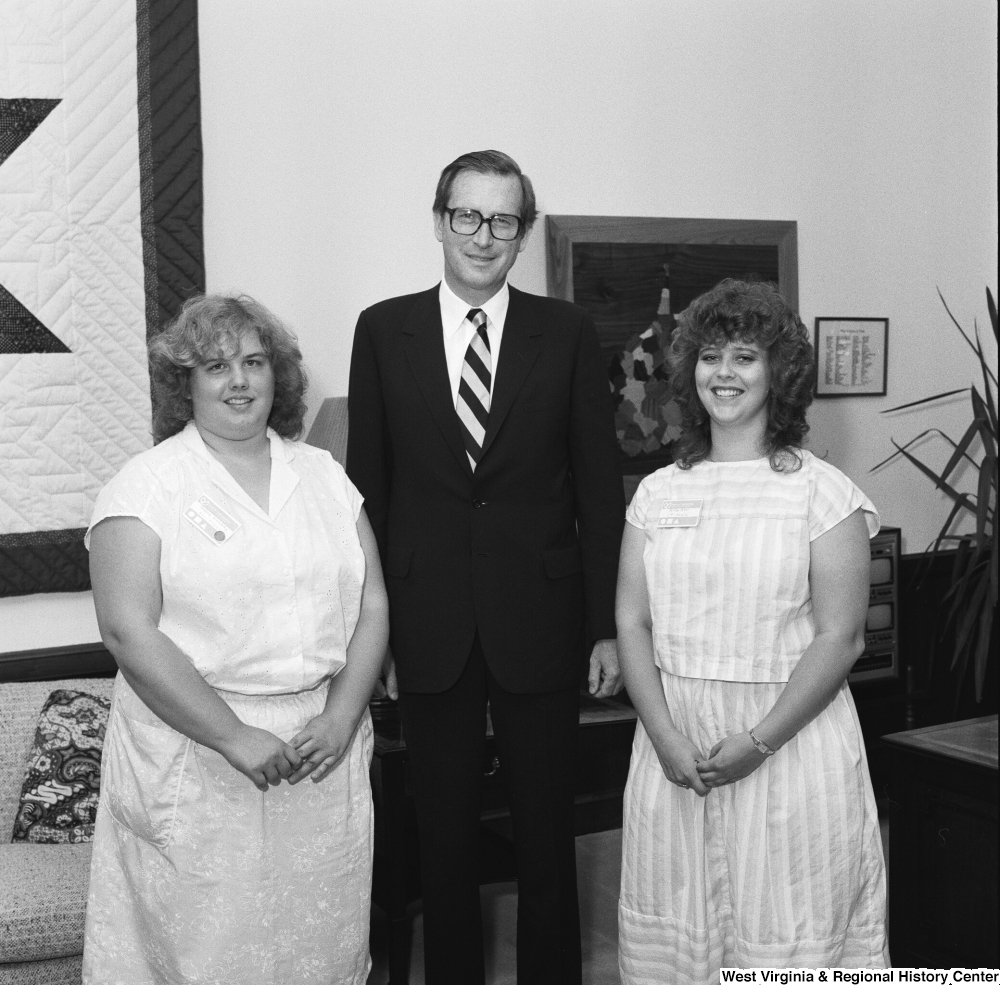 ["Two unidentified individuals pose for a photograph with Senator John D. (Jay) Rockefeller in his Washington office."]%