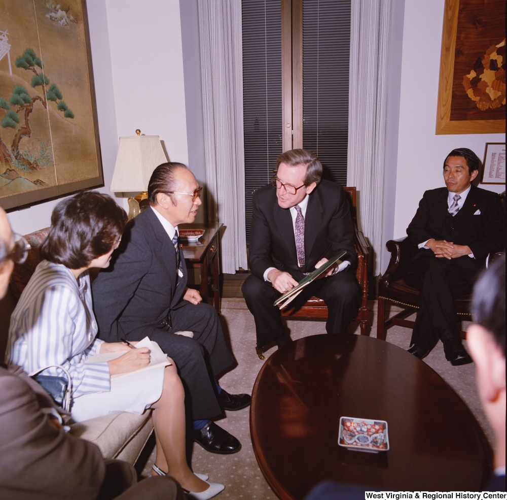 ["Senator John D. (Jay) Rockefeller speaks with members of a Japanese Embassy delegation in his office."]%