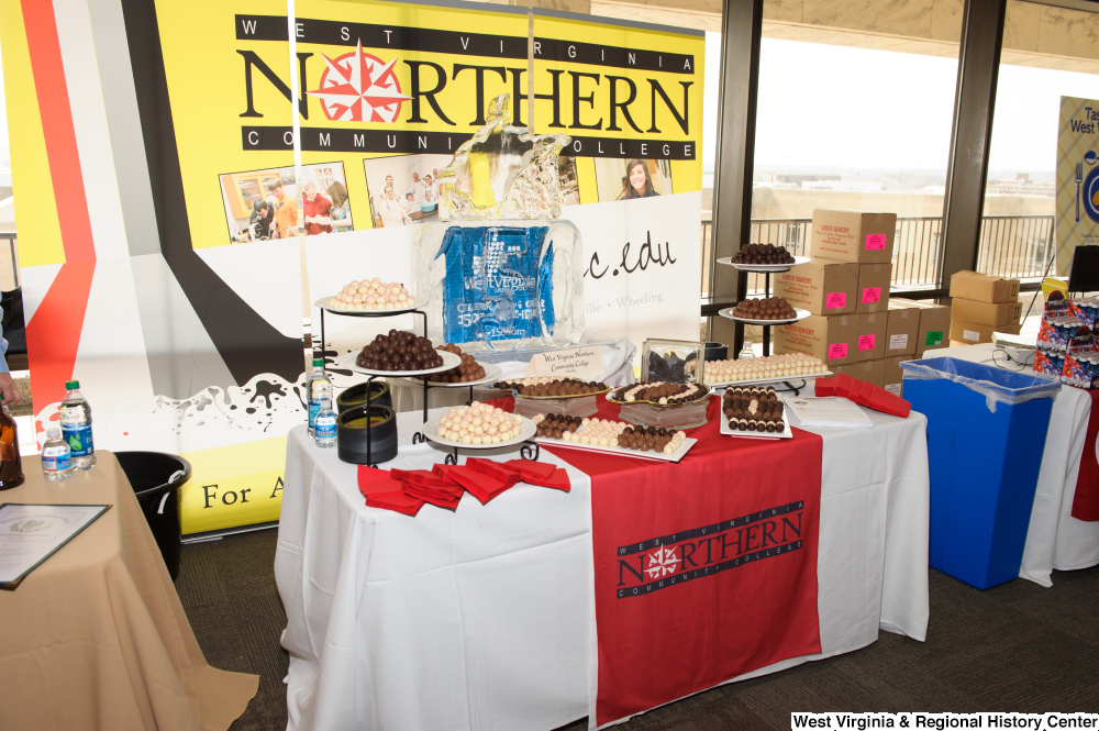 ["The West Virginia Northern Community College has a table of chocolates at the 150th birthday celebration for West Virginia."]%