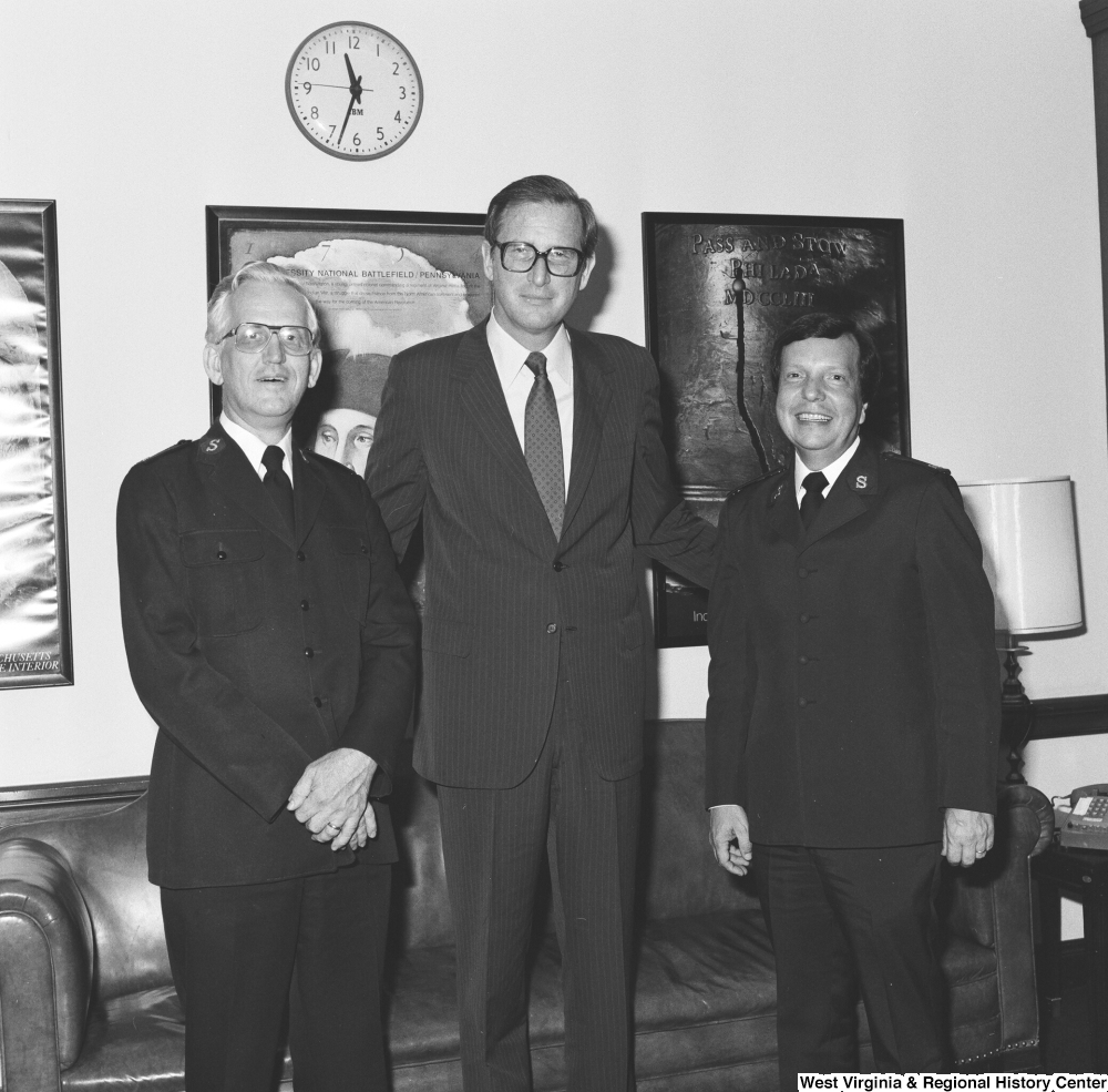 ["Senator John D. (Jay) Rockefeller smiles and stands for a photograph with Major Cooper and Major Jaynes of the Salvation Army."]%