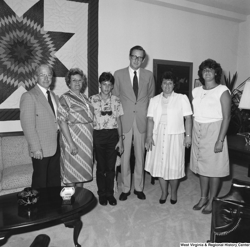 ["Senator John D. (Jay) Rockefeller poses for a photograph with an unidentified group of visitors from West Virginia in his Washington, D.C. office."]%