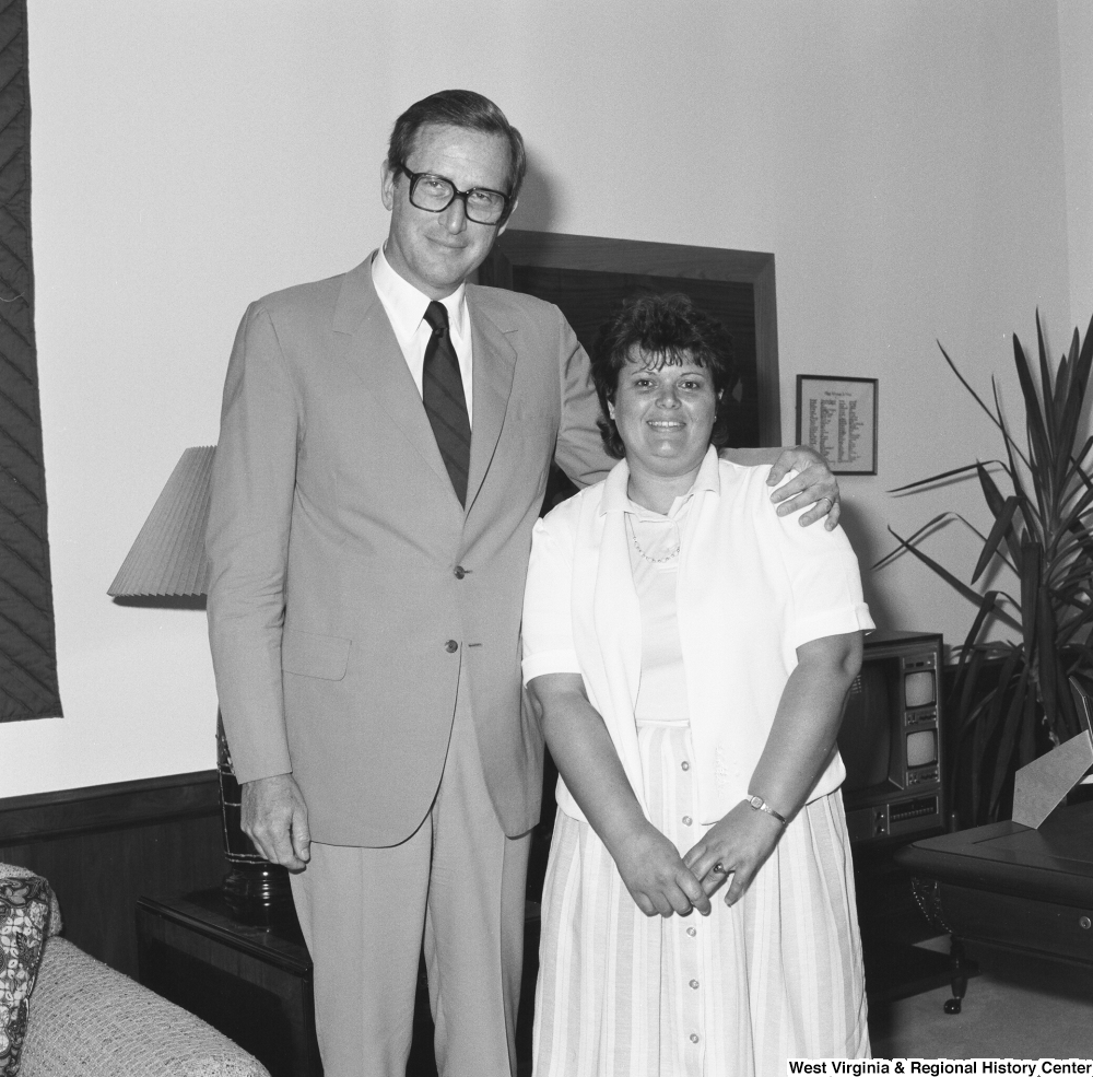 ["Senator John D. (Jay) Rockefeller stands for a photograph with an unidentified woman from West Virginia in his Washington office."]%