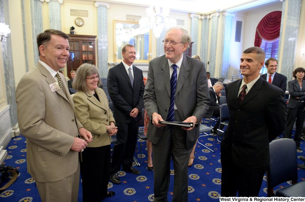 ["Senator John D. (Jay) Rockefeller and Bill Nelson of USA Cares talk before a Senate Commerce Committee hearing."]%