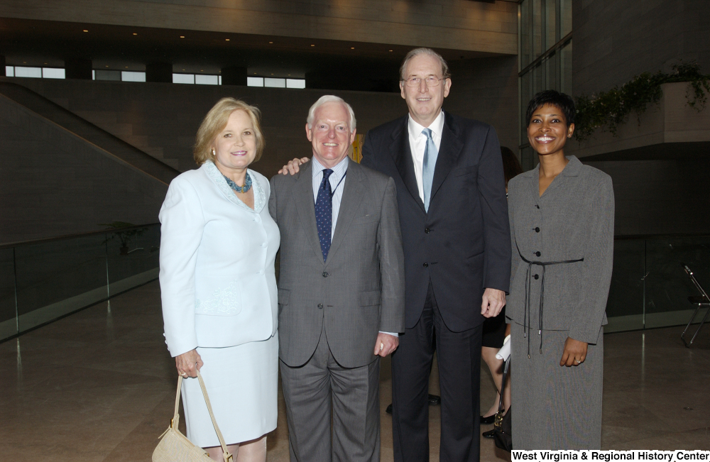 ["Senator John D. (Jay) Rockefeller and Sharon Rockefeller stand with two unidentified individuals."]%