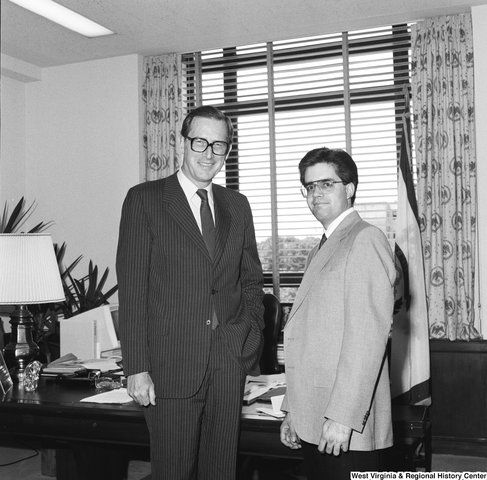 ["Senator John D. (Jay) Rockefeller stands for a photograph with an unidentified man in his Washington office."]%