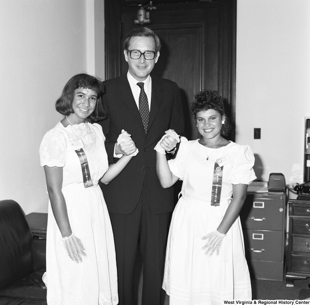 ["Senator John D. (Jay) Rockefeller holds the hands of the two Girls Nation participants from West Virginia. Girls Nation is a national civic training and learning experience that is facilitated by the American Legion Auxiliary."]%