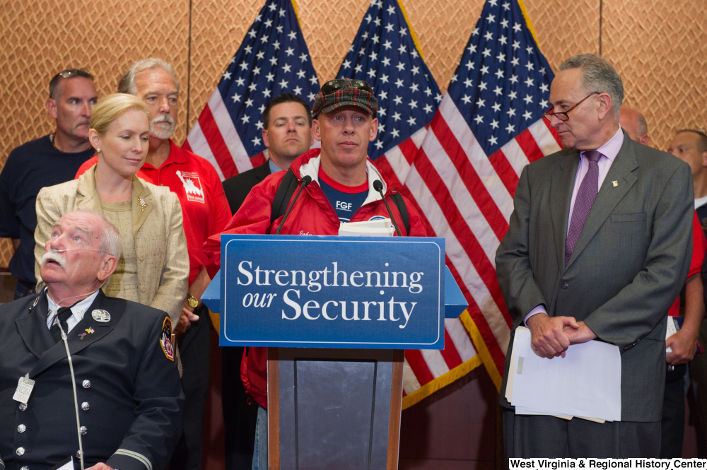 ["An unidentified man speaks at a Strengthening our Security event."]%