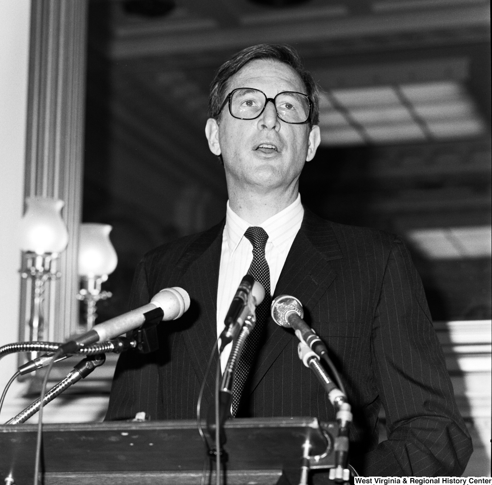 ["Close up of Senator John D. (Jay) Rockefeller speaking at a press event in a Senate building."]%