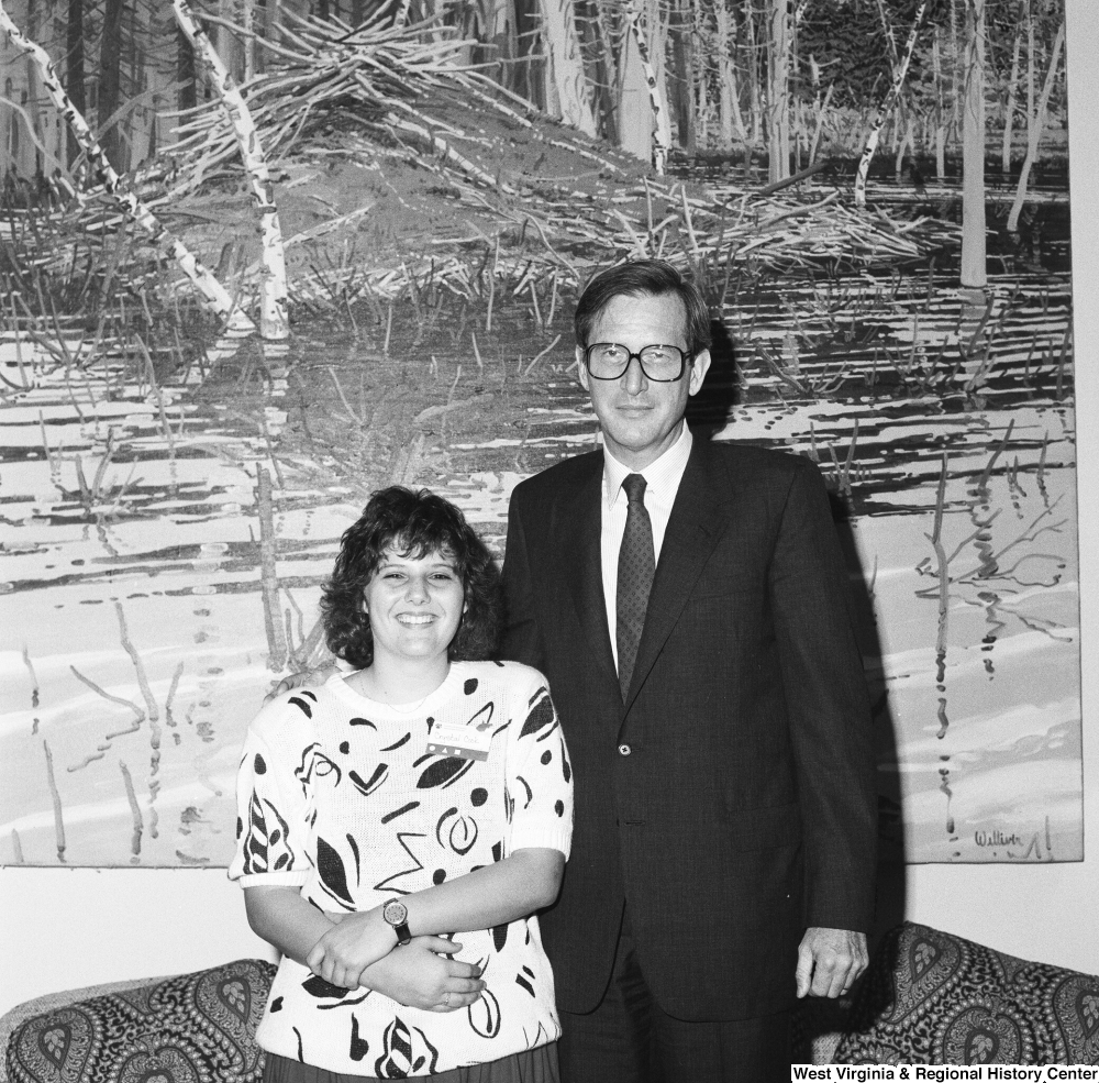 ["Senator John D. (Jay) Rockefeller stands next to an unidentified West Virginia woman in his office."]%