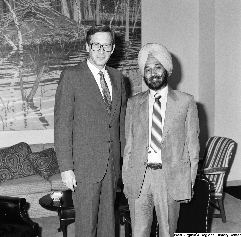 ["Senator John D. (Jay) Rockefeller stands next to an unidentified man in his office."]%