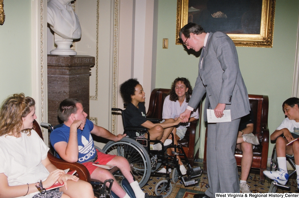 ["Senator John D. (Jay) Rockefeller shakes hands with a member of the Center for Independent Living from Huntington, West Virginia."]%