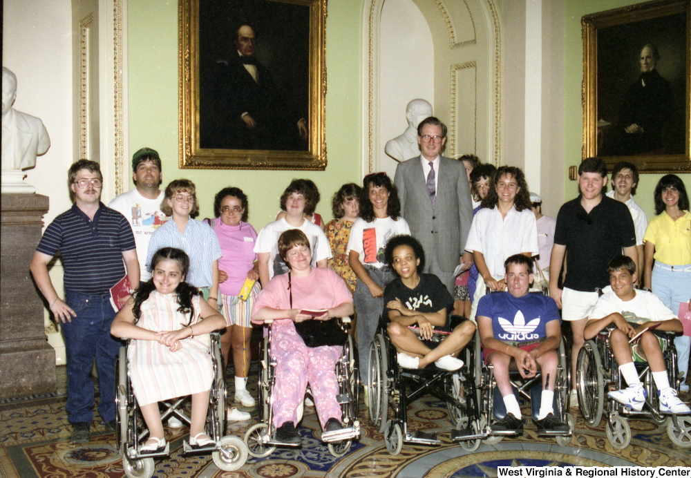 ["Senator John D. (Jay) Rockefeller stands with members of the Center for Independent Living."]%