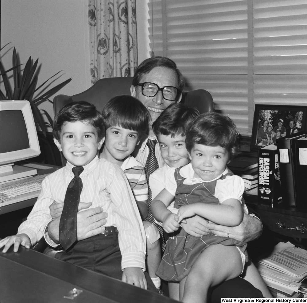 ["Four unidentified children sit on Senator John D. (Jay) Rockefeller's lap behind the desk in his Washington office."]%