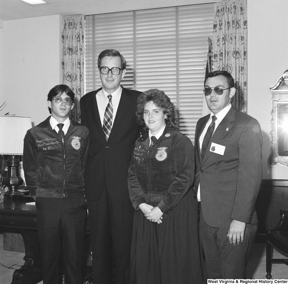 ["Senator John D. (Jay) Rockefeller stands for a photograph in his office with three representatives from Future Farmers of America."]%