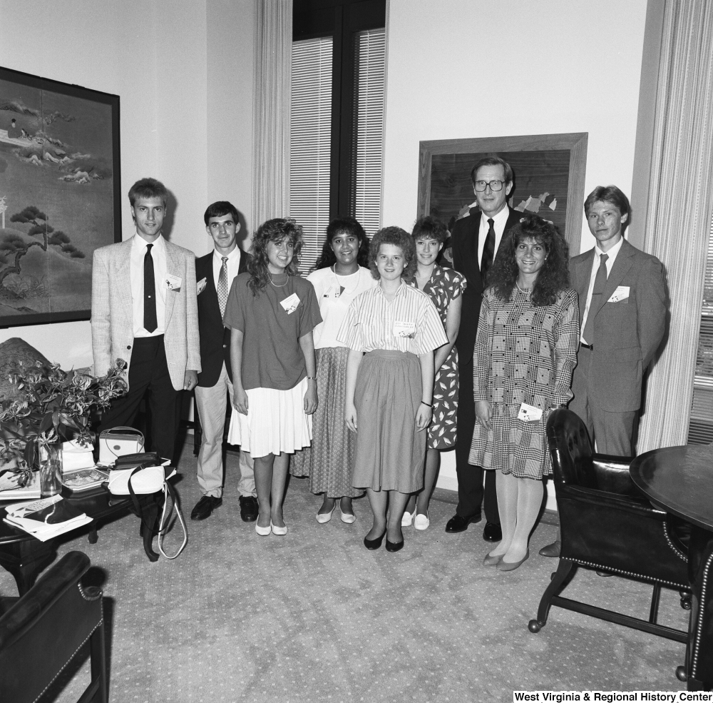 ["Senator John D. (Jay) Rockefeller stands in his office with a large group of students who are participating in the National Youth Leadership Conference."]%